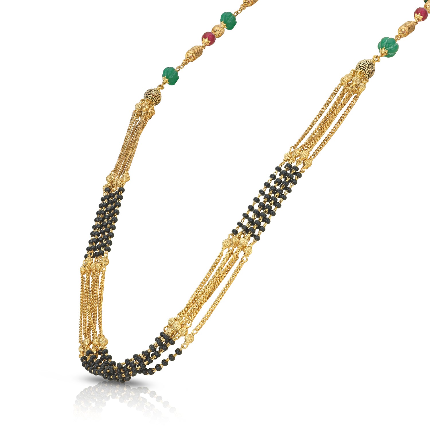Gold necklace with black and green beads on a white background