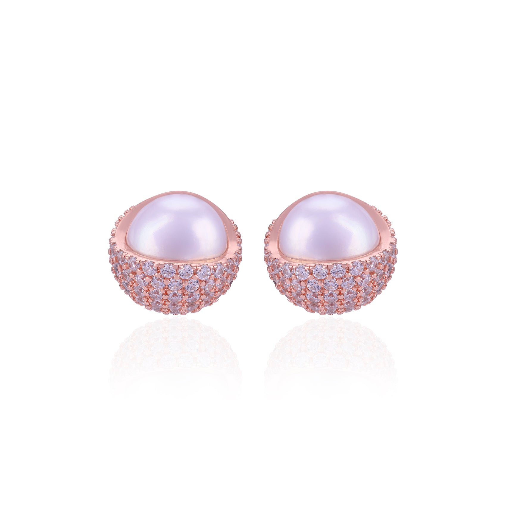 Pair of pearl earrings with rose gold and clear gemstone accents on a white background