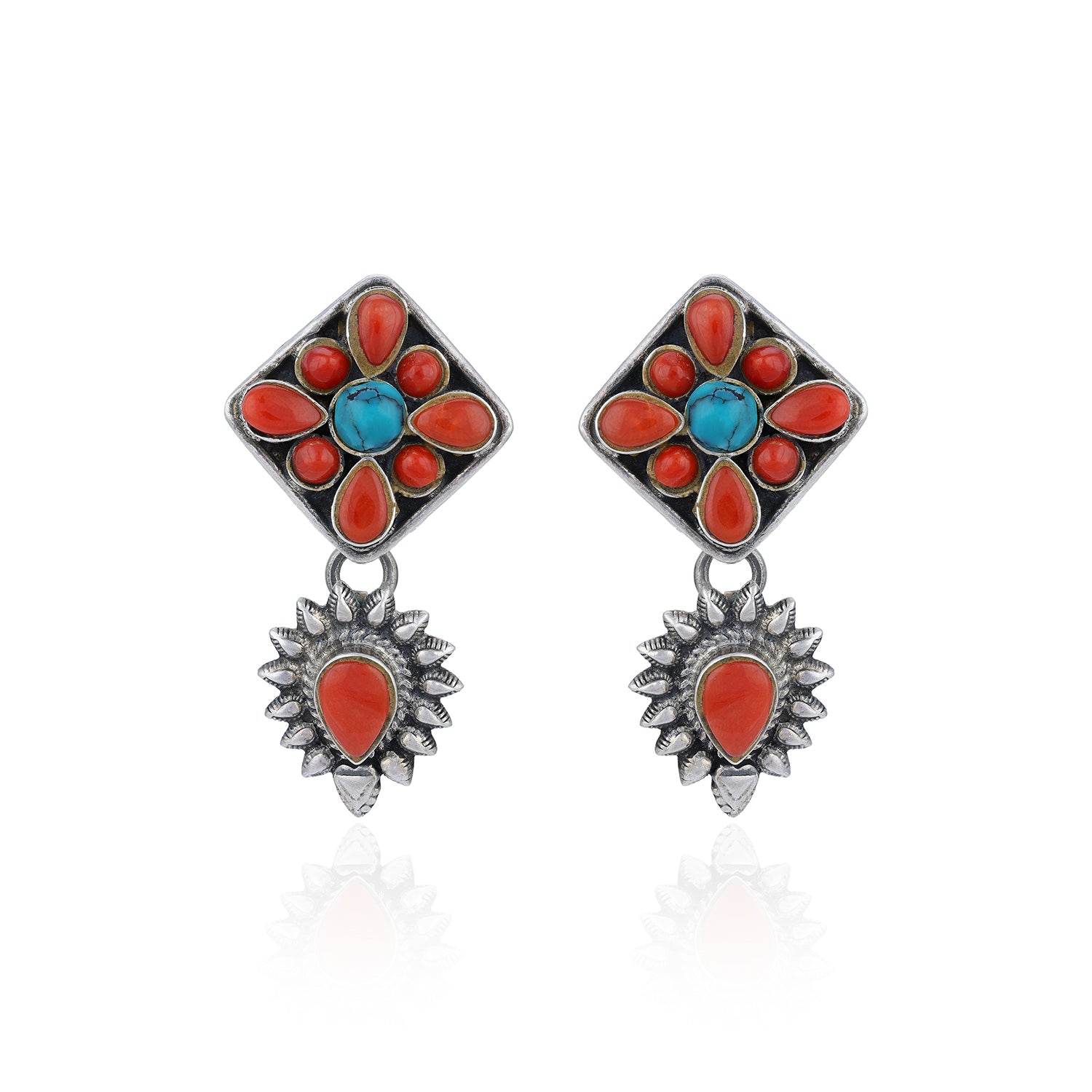 Pair of earrings with floral design featuring red and blue stones on a white background