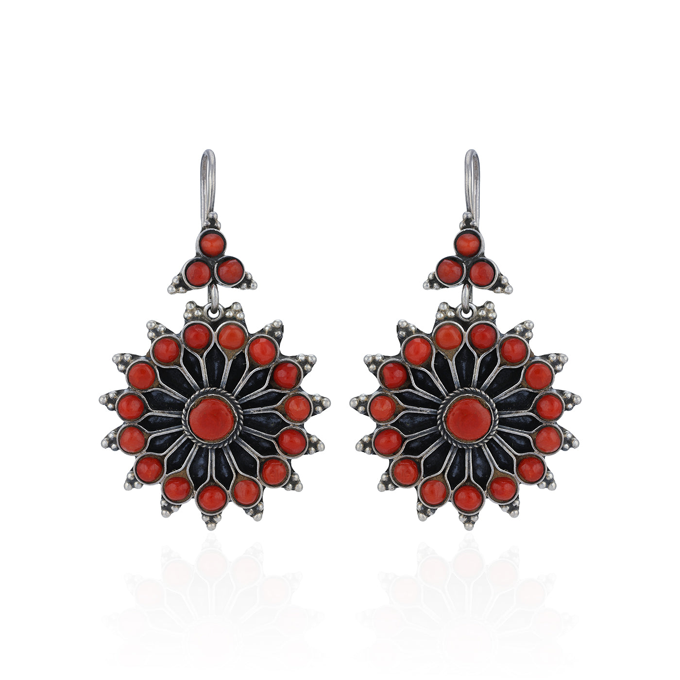 Pair of earrings with red and black floral design on a white background