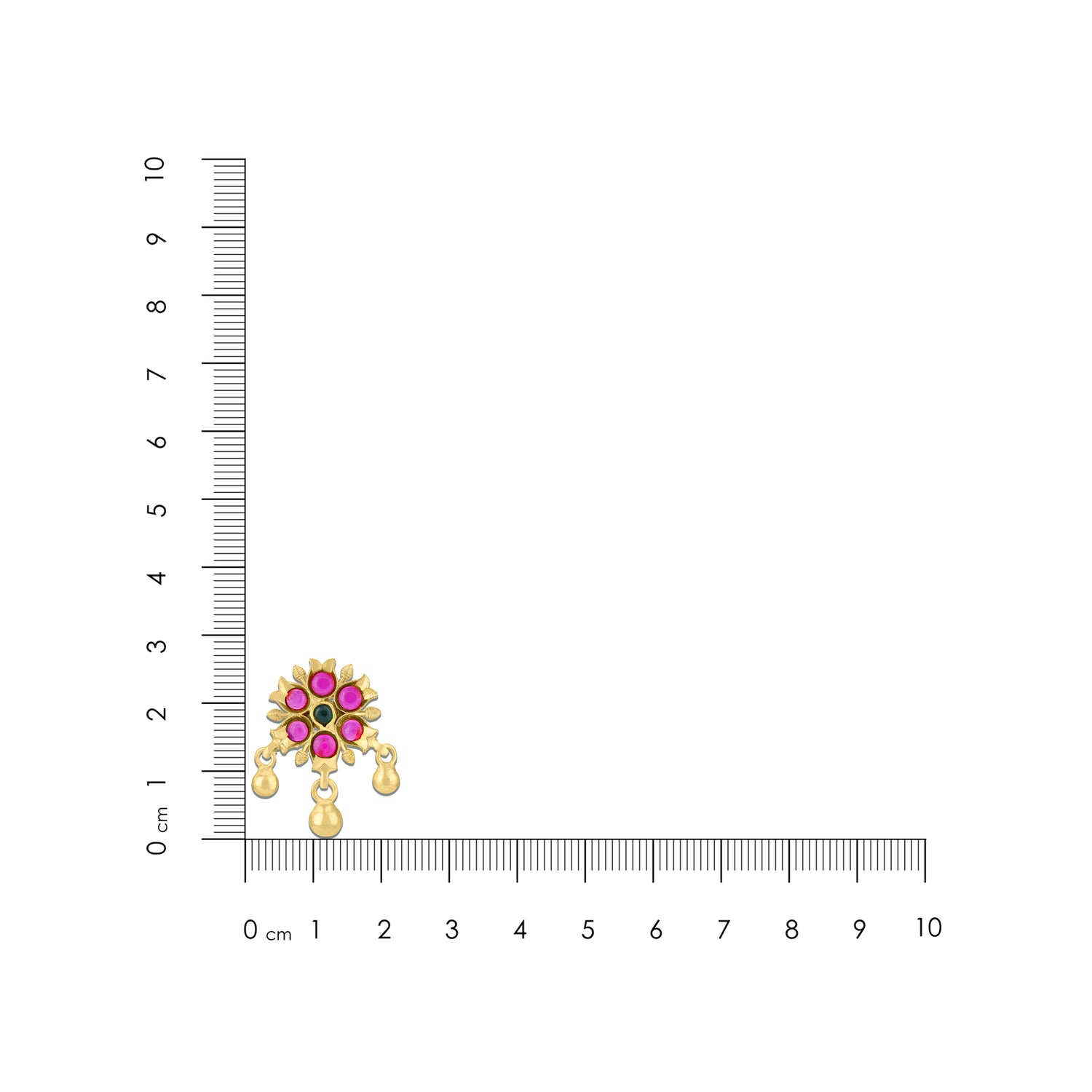 Gold earring with gemstones next to a ruler for scale on a white background