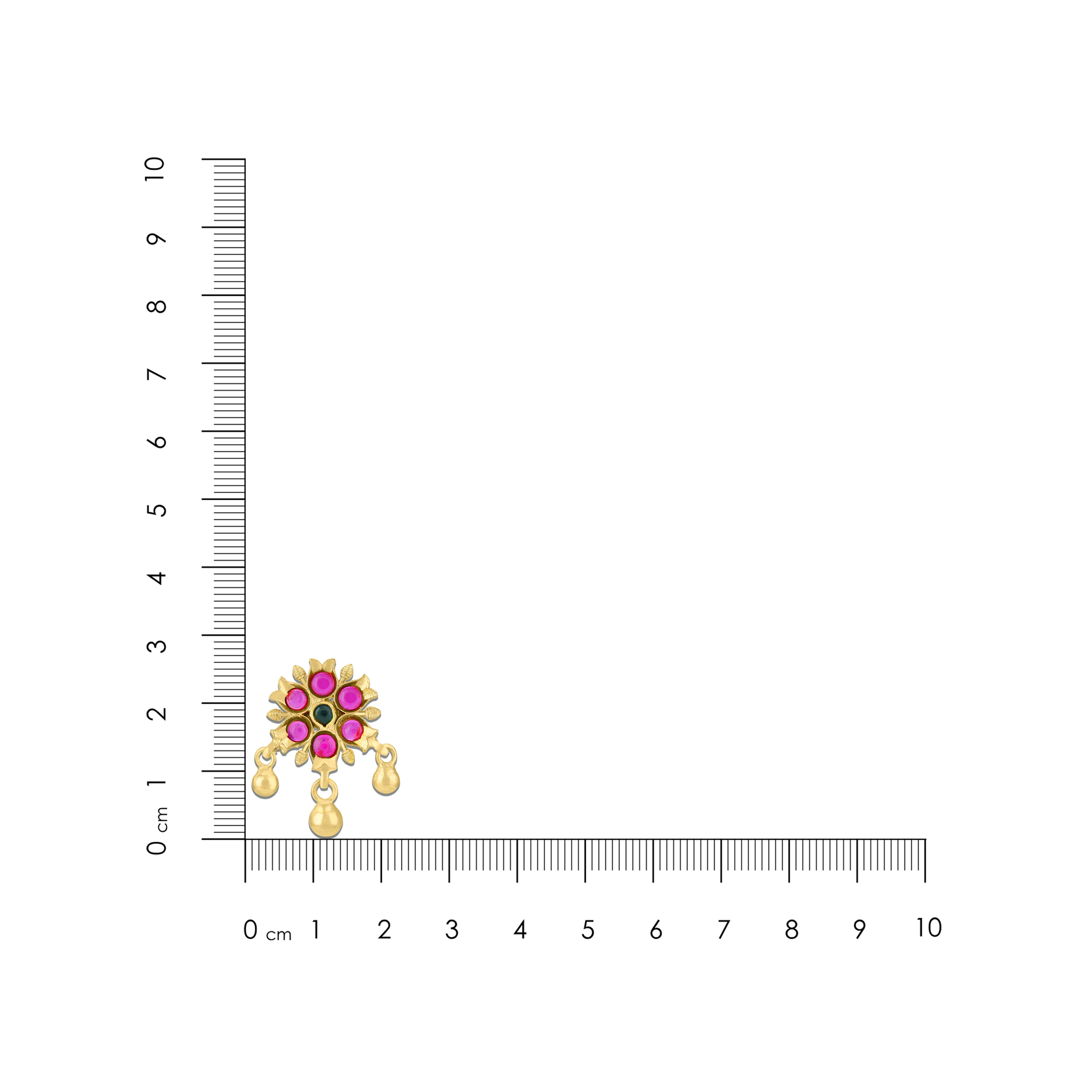 Gold earring with gemstones next to a ruler for scale on a white background