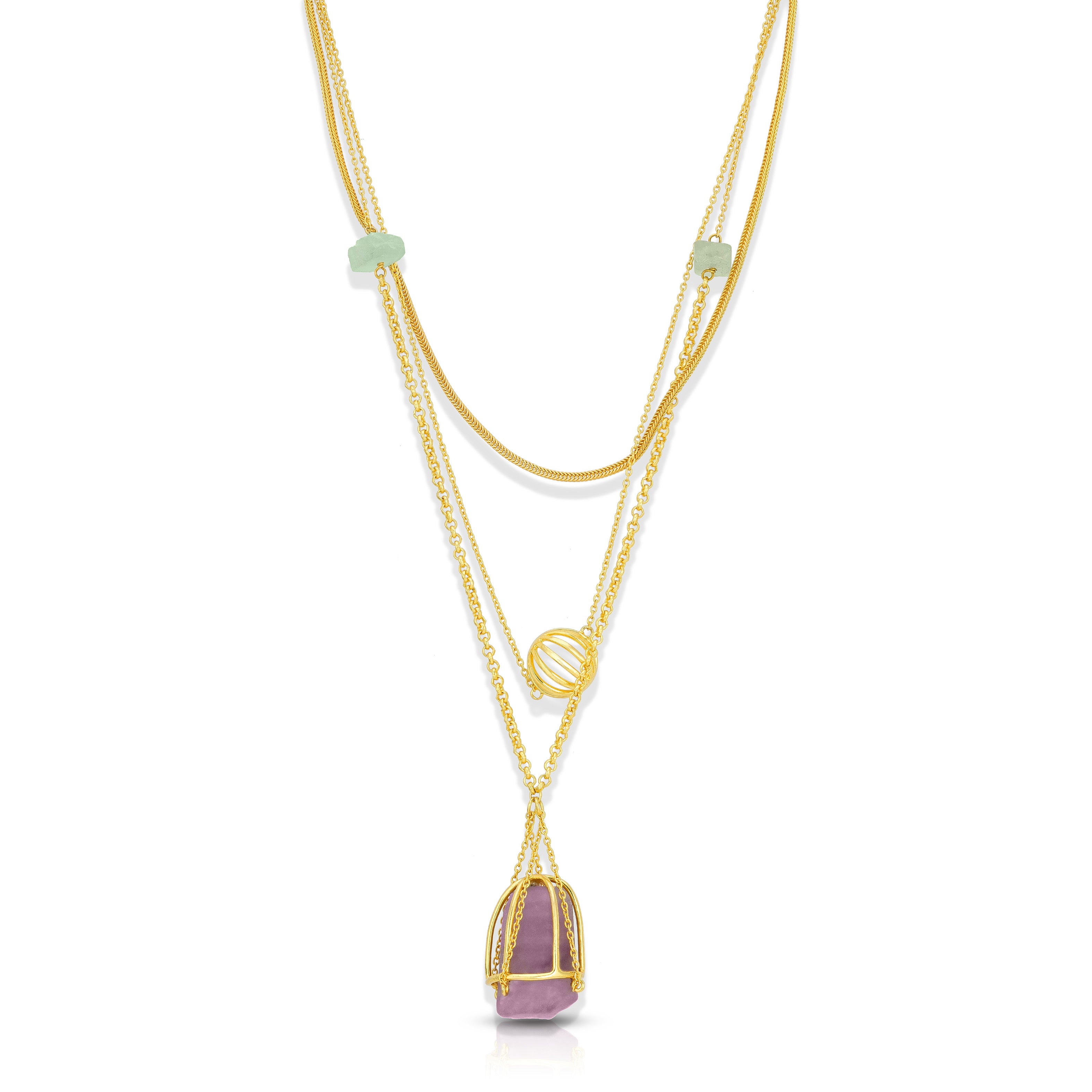 Layered gold necklaces with gemstone pendants on a white background