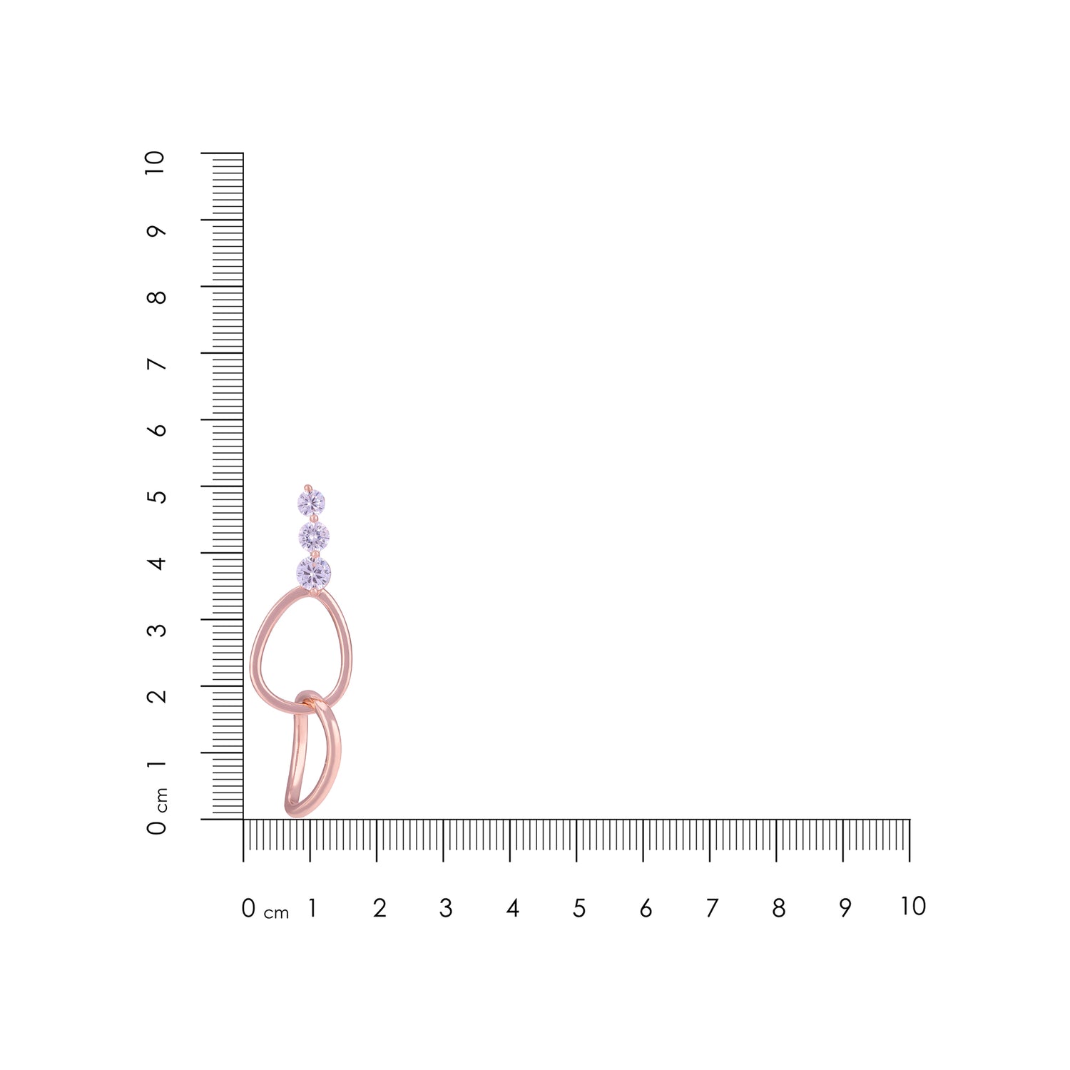 Rose gold earrings with purple gemstones on a ruler for scale