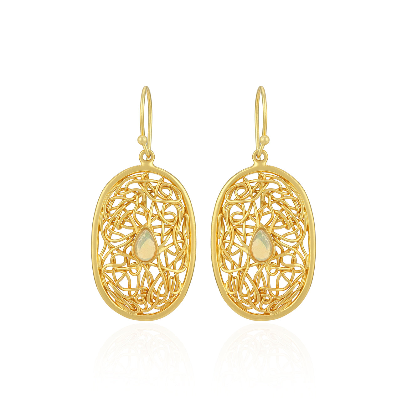 Gold filigree earrings with teardrop-shaped centers on a white background