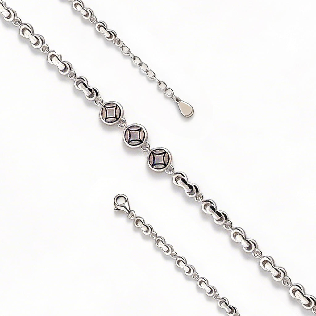 Silver chain with diamond-like beads on a white background