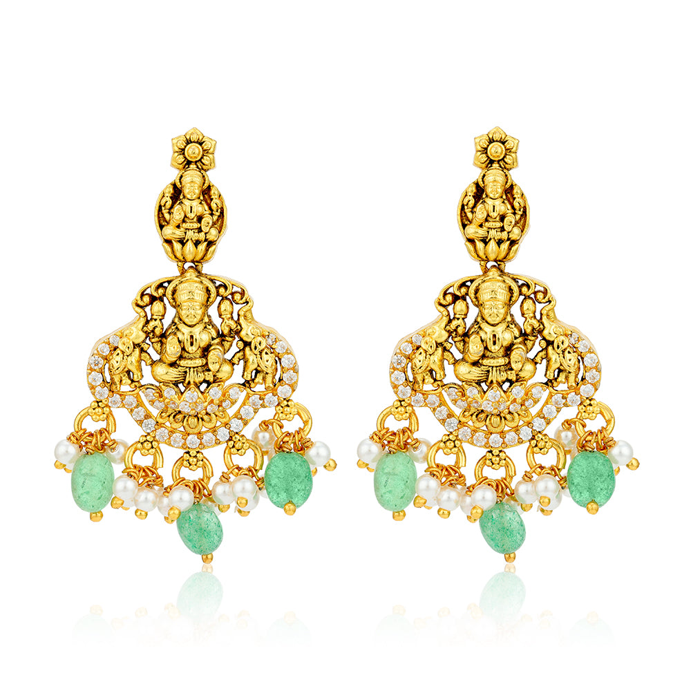 Gold earrings with green stones and pearls on a white background