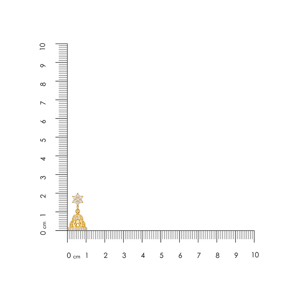 Gold star-shaped pendant next to a ruler on a white background