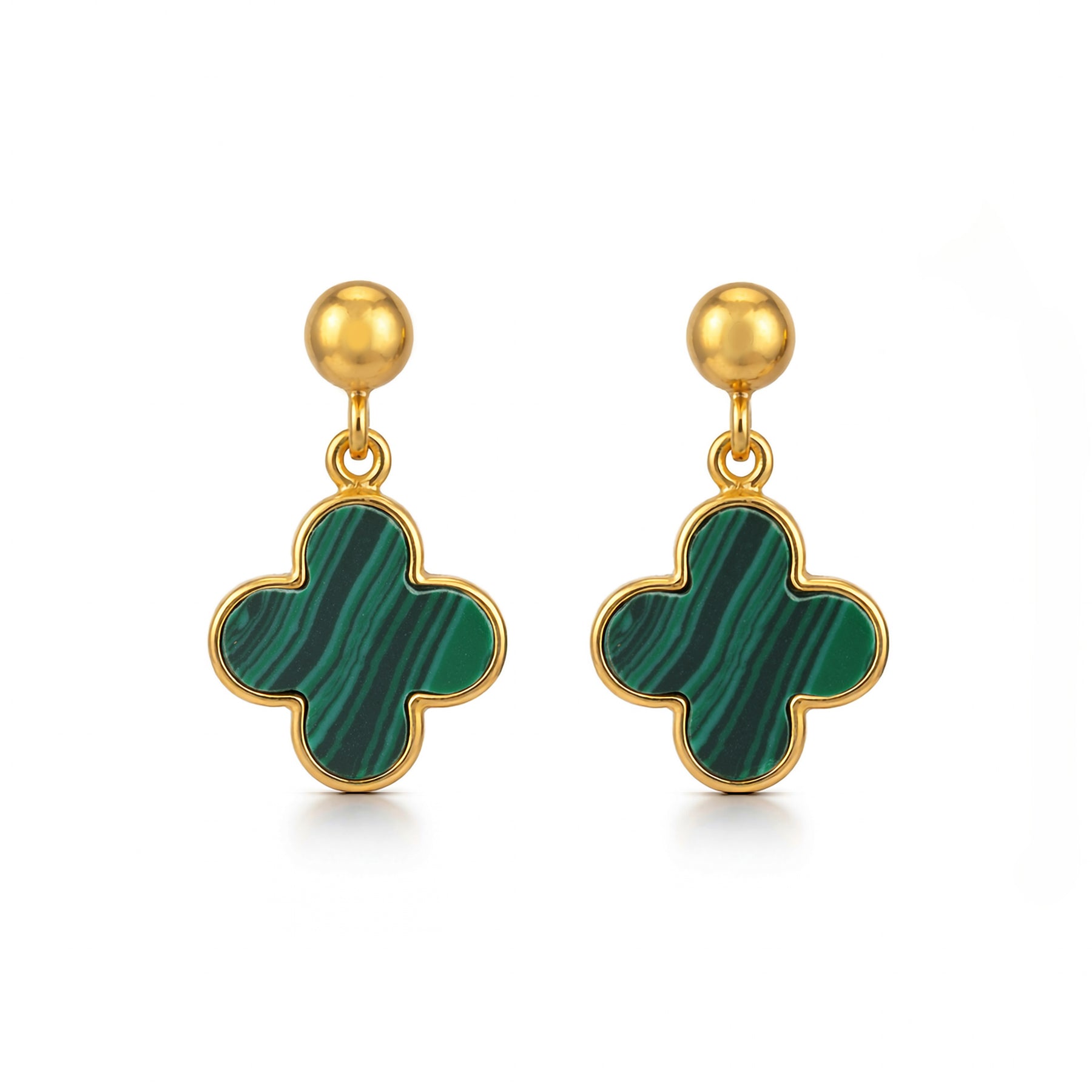 Gold earrings with green clover-shaped drops on a white background