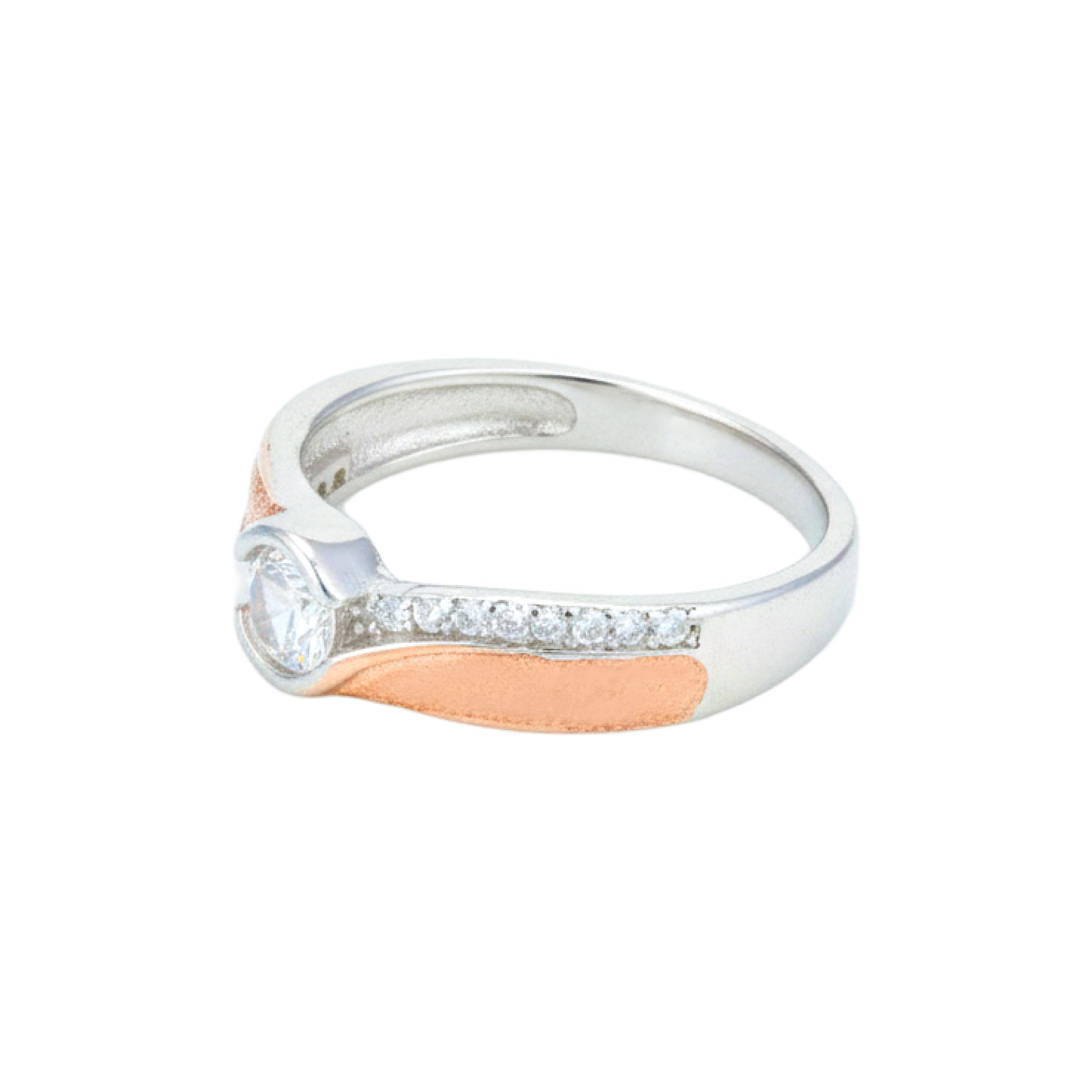 Two-tone ring with a diamond on a white background