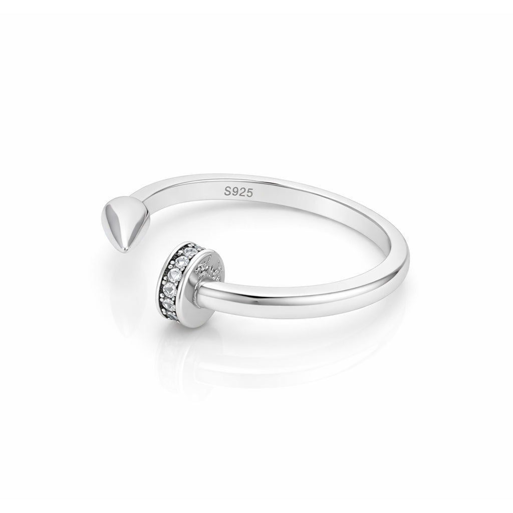 Silver ring with a small circular design on a white background