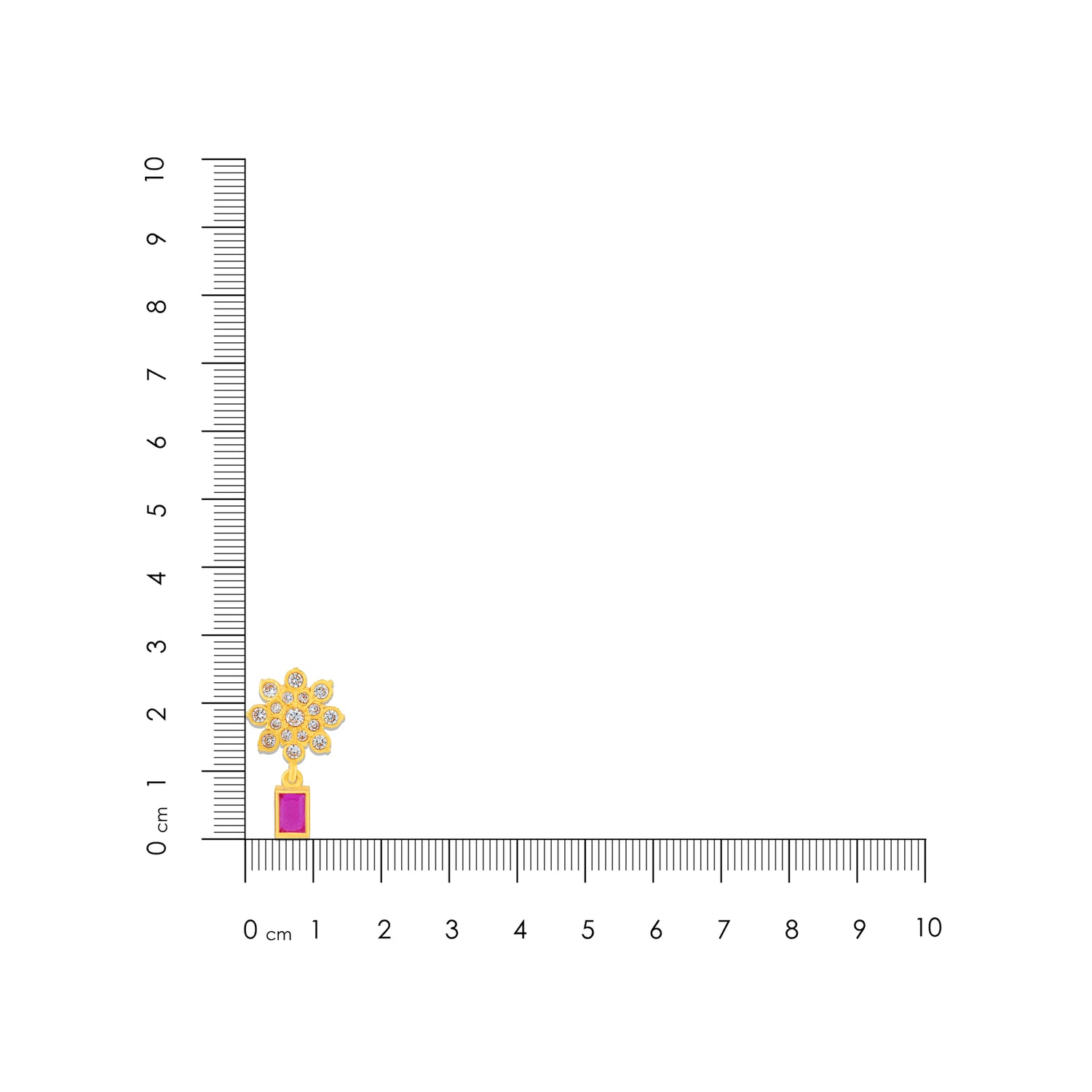 Gold and red gemstone earring next to a ruler on a white background