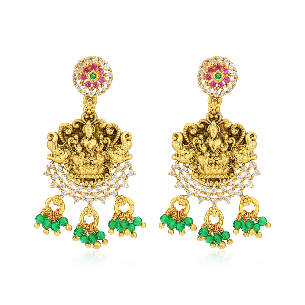 Gold earrings with green and red gemstones on a white background