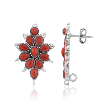 Coral and silver earring on a white background