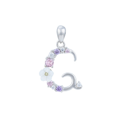 Silver pendant with floral and moon design on a white background