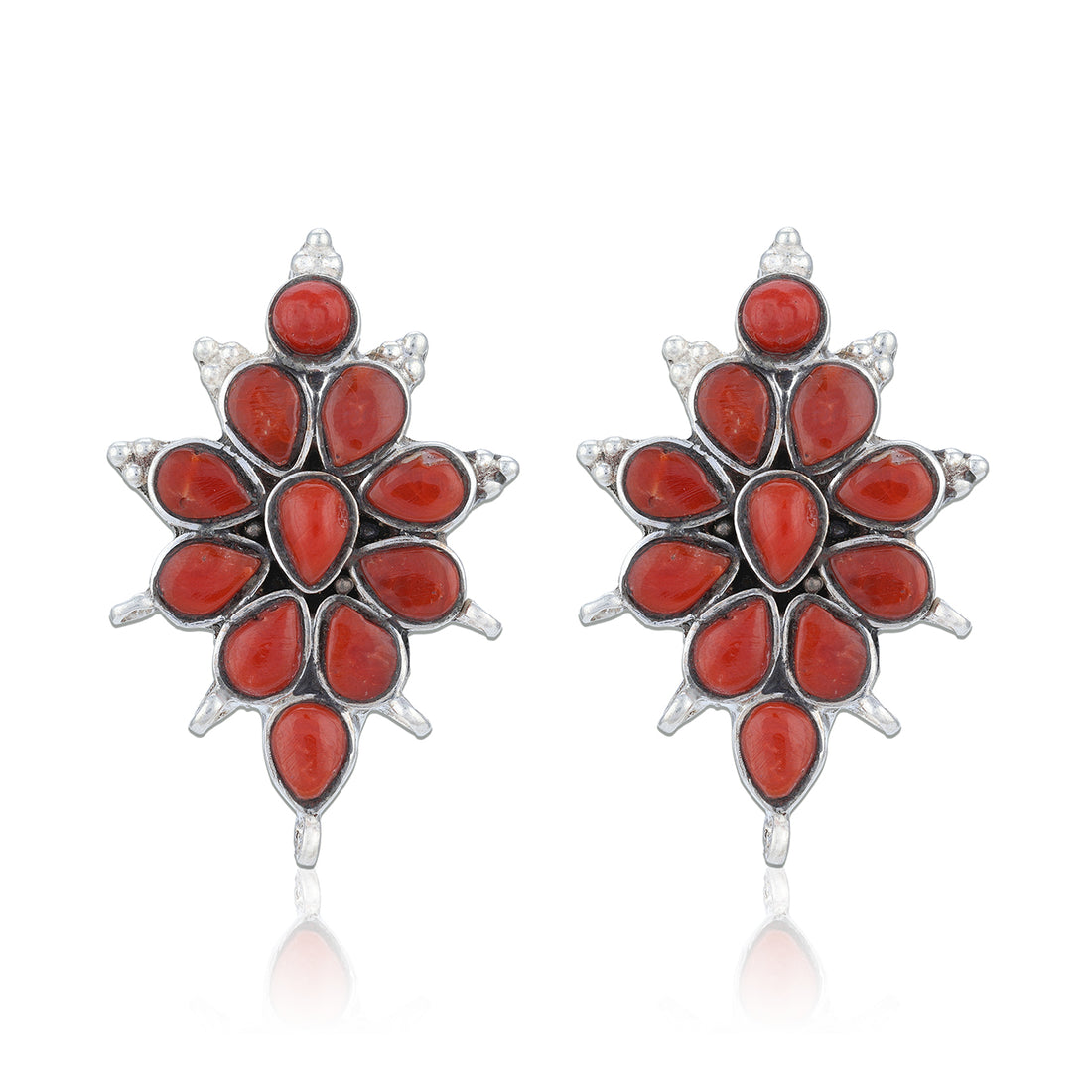 Pair of red floral earrings with silver accents on a white background
