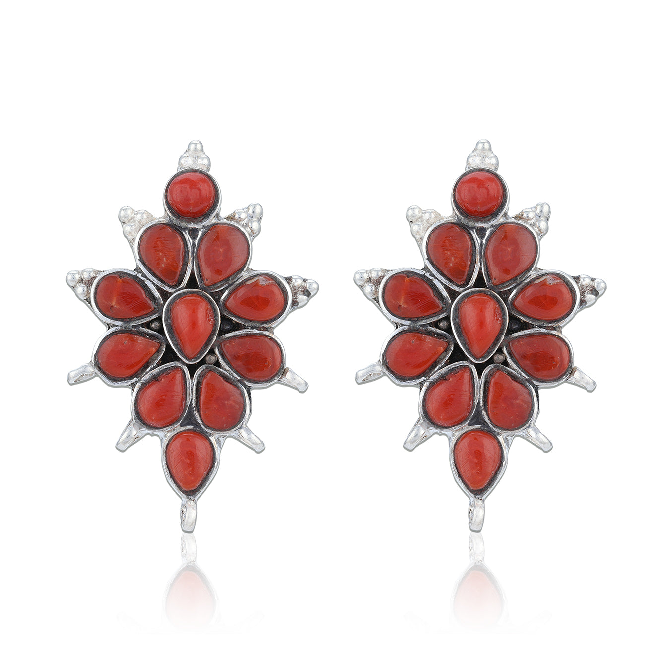 Pair of red floral earrings with silver accents on a white background