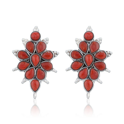 Pair of red floral earrings with silver accents on a white background