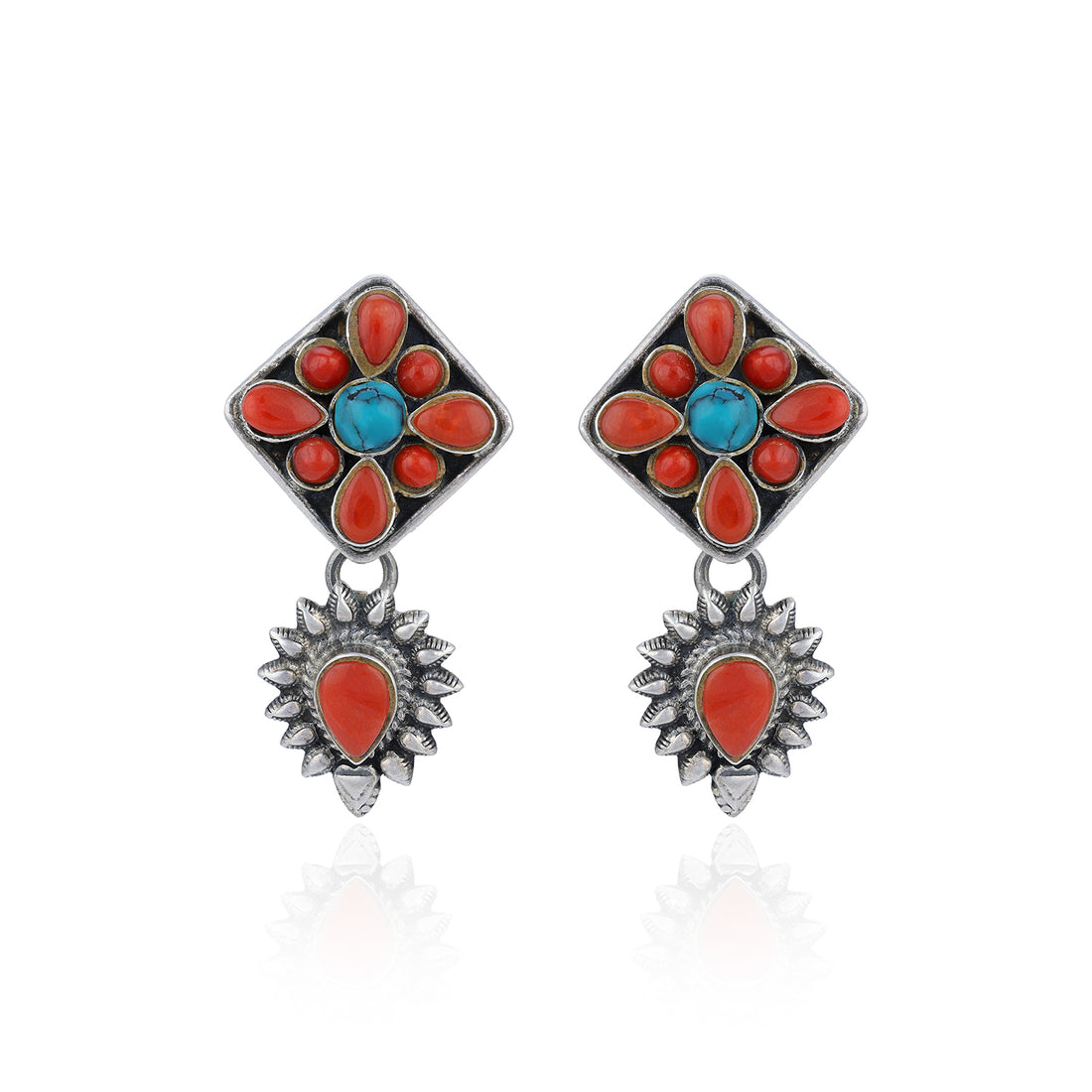 Pair of earrings with floral design featuring red and blue stones on a white background