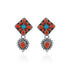 Pair of earrings with floral design featuring red and blue stones on a white background