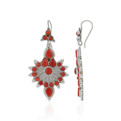 Silver earrings with red gemstones on a white background