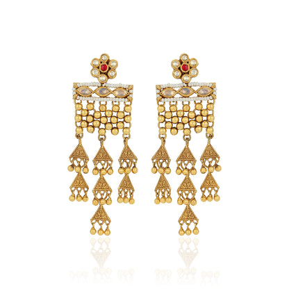 Gold earrings with red gemstones on a white background