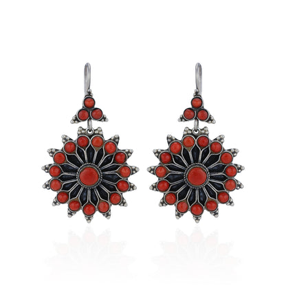 Pair of earrings with red and black floral design on a white background