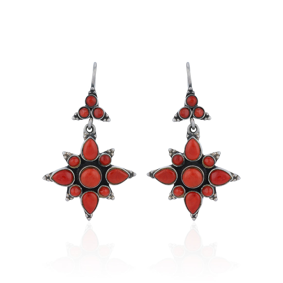 Star-shaped earrings with red stones on a white background