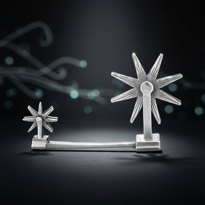 Silver star-shaped object on a dark background