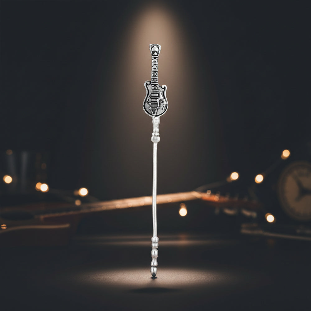 Decorative silver stickpin on a blurred background with warm lighting