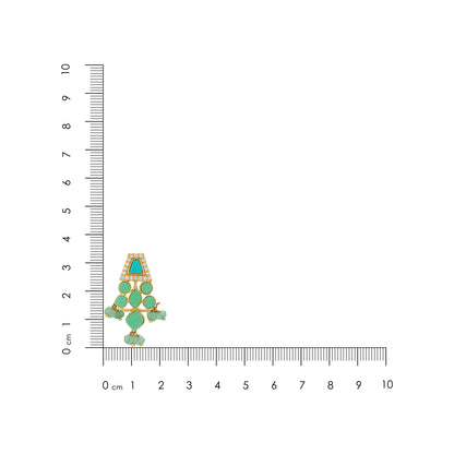 Jewelry pendant with green gemstones and gold accents next to a ruler for scale on a white background