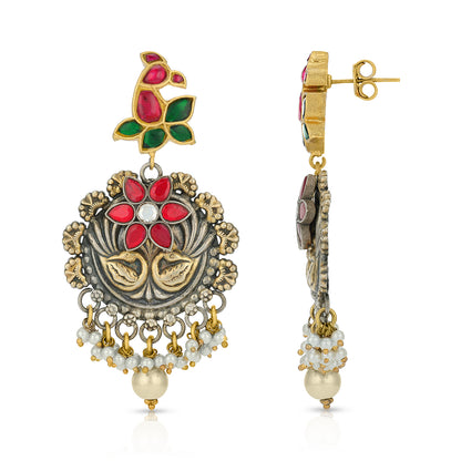 Ornate earrings with floral design and pearl accents on a white background