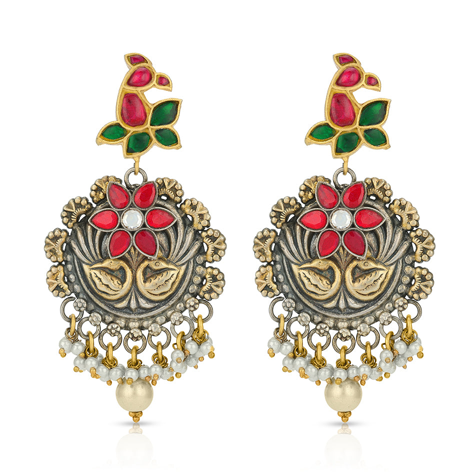 Ornate earrings with red, green, and gold colors on a white background