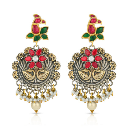 Ornate earrings with red, green, and gold colors on a white background