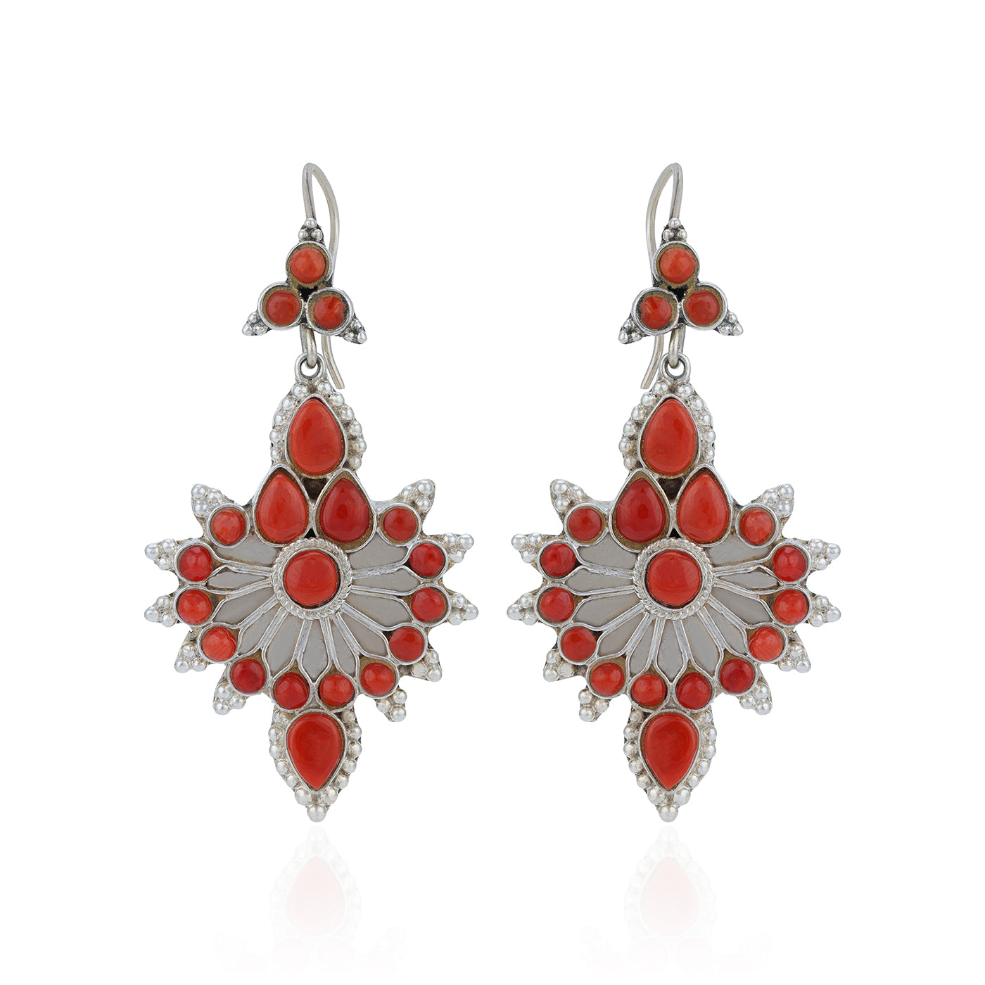 Pair of silver earrings with red stones on a white background