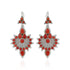Pair of silver earrings with red stones on a white background