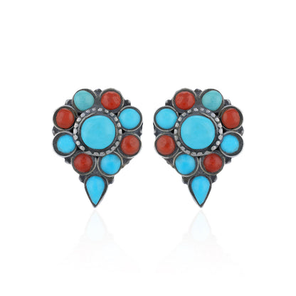 Pair of earrings with turquoise and red stones on a white background