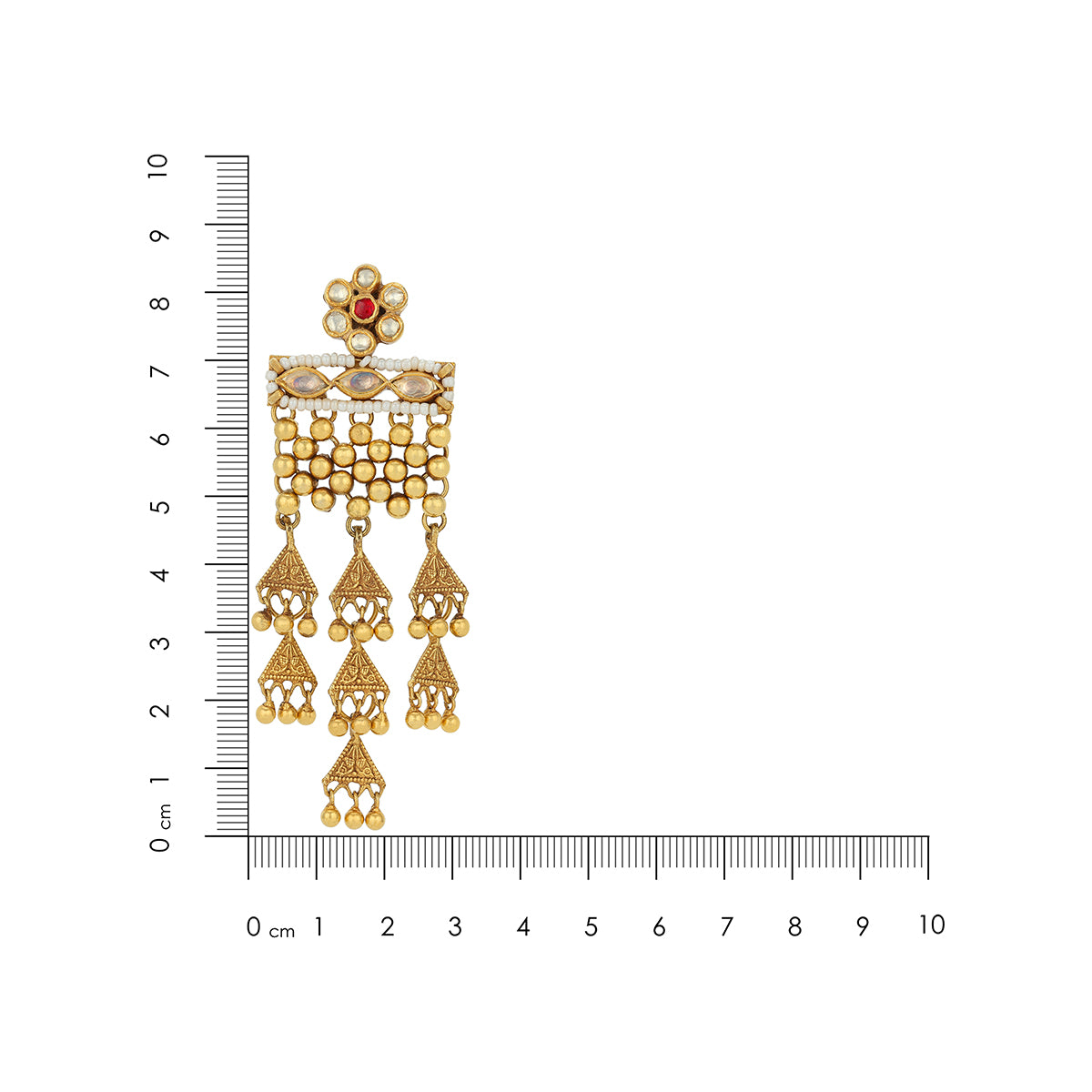 Gold earrings with a red gemstone next to a ruler for scale on a white background