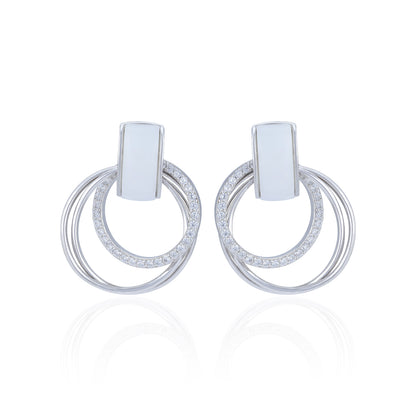Pair of silver hoop earrings with small stones on a white background
