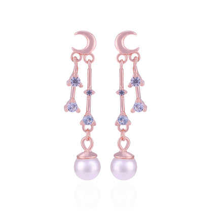 Rose gold earrings with pearl drops and gemstones on a white background