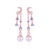 Rose gold earrings with pearl drops and gemstones on a white background