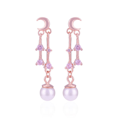 Pair of pink earrings with moon designs and pearl-like beads on a white background