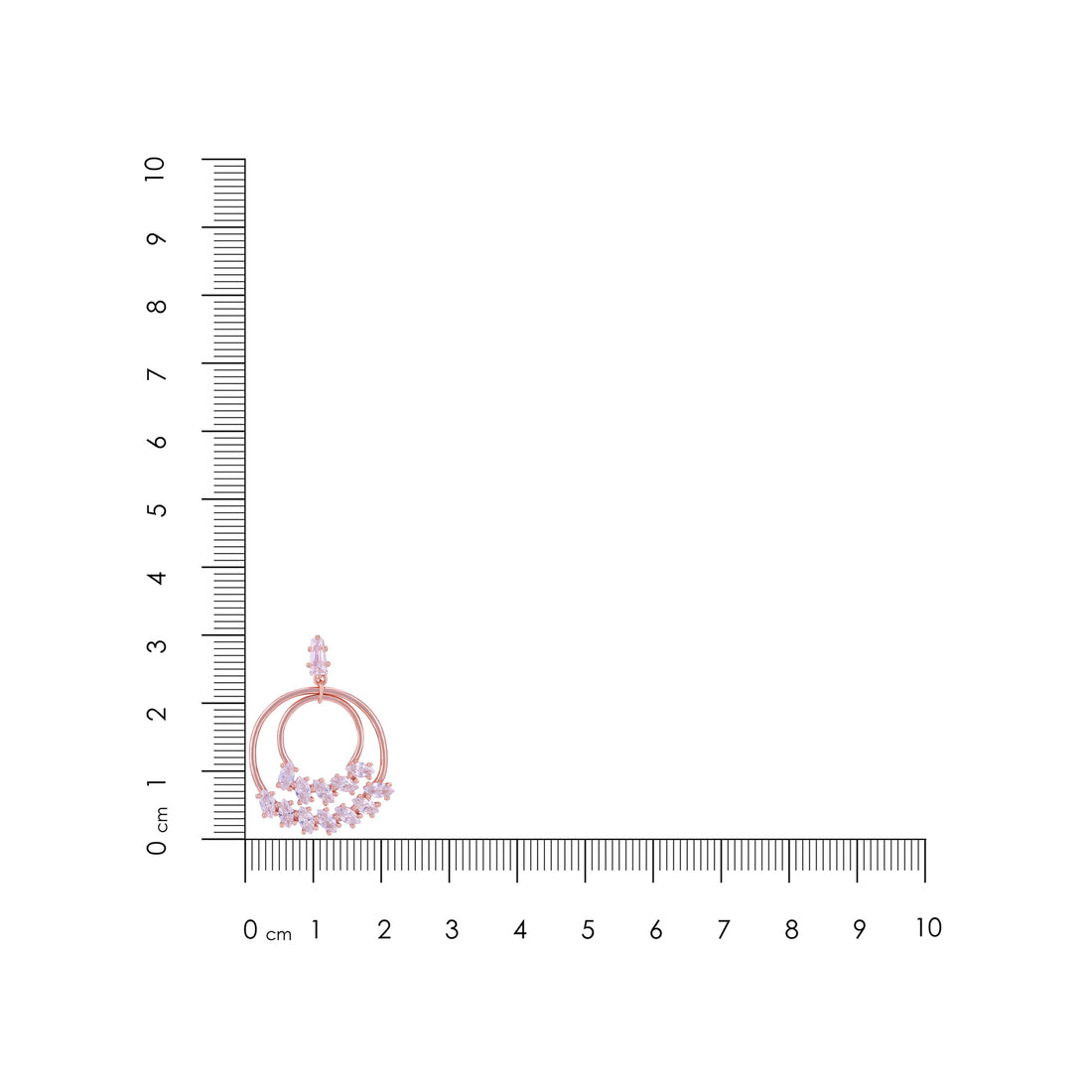 Jewelry with pink gemstones next to a ruler on a white background