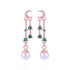 Rose gold earrings with green gemstones and pearl drops on a white background