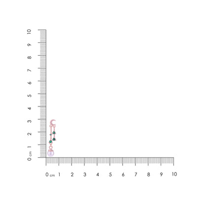 Jewelry with a pink and green pendant on a ruler for scale