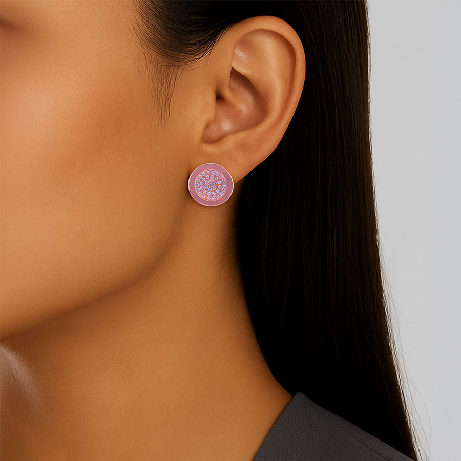 Close-up of an ear wearing a pink floral earring with a neutral background