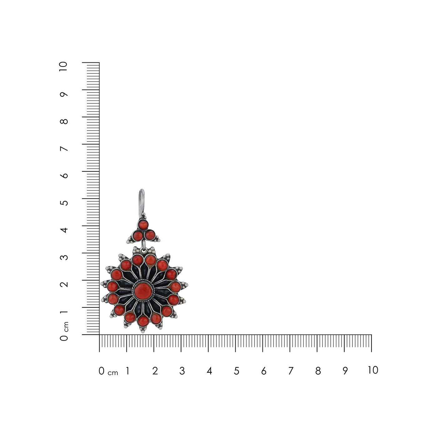 Pendant with red and black design next to a ruler on a white background