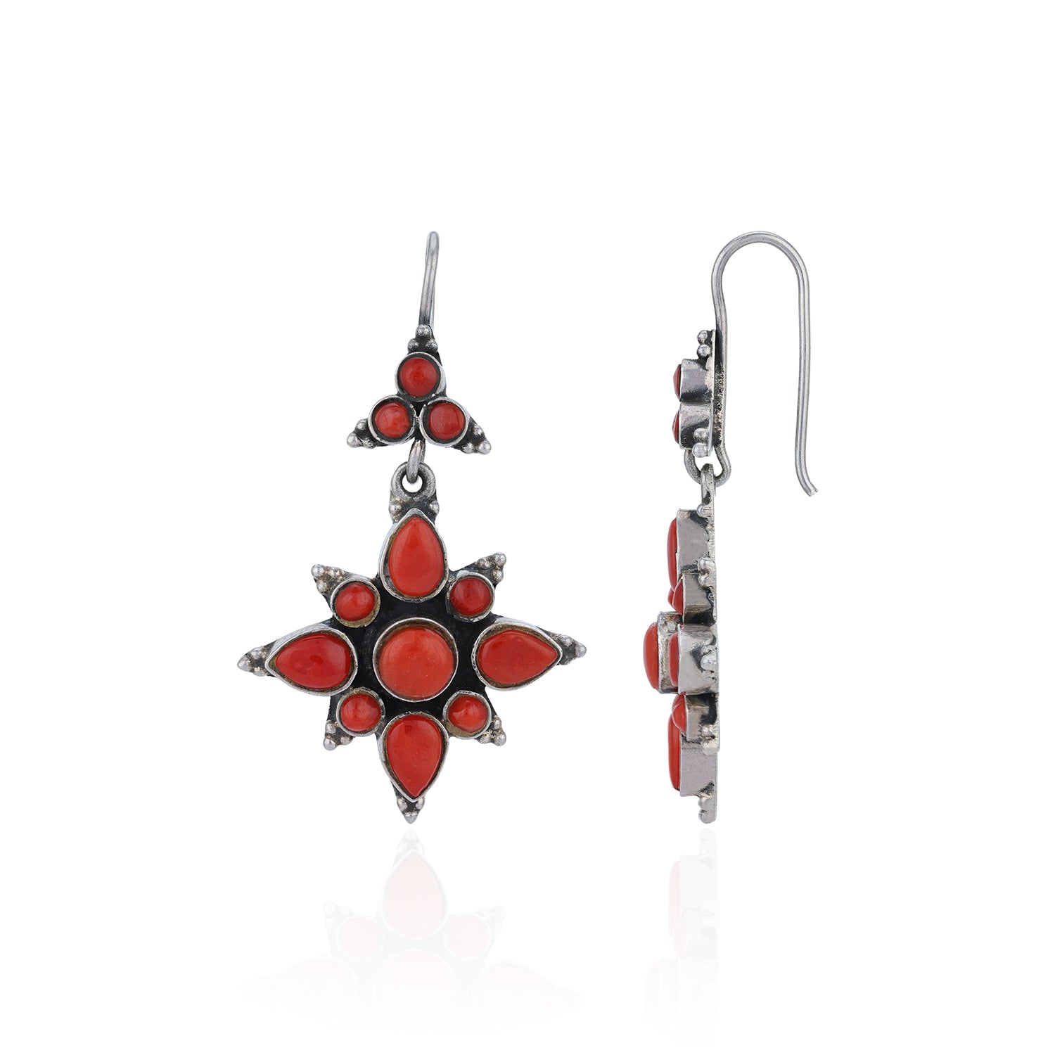 Star-shaped earrings with red stones on a white background
