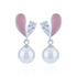 Pearl earrings with pink heart-shaped accents