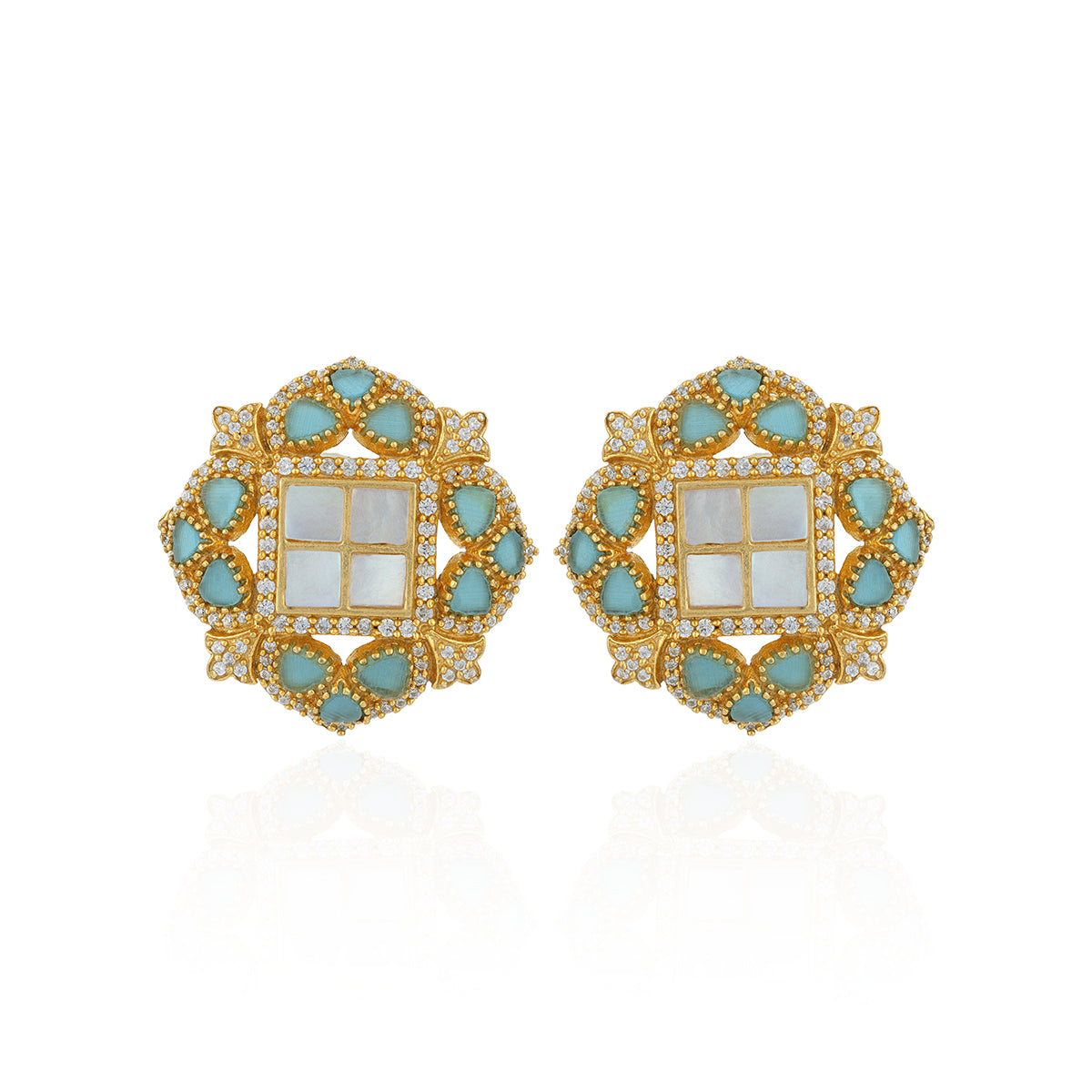 Pair of ornate earrings with gold frame, turquoise stones, and white center on a white background